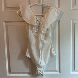 White lace up ribbed bodysuit with ruffle shoulder